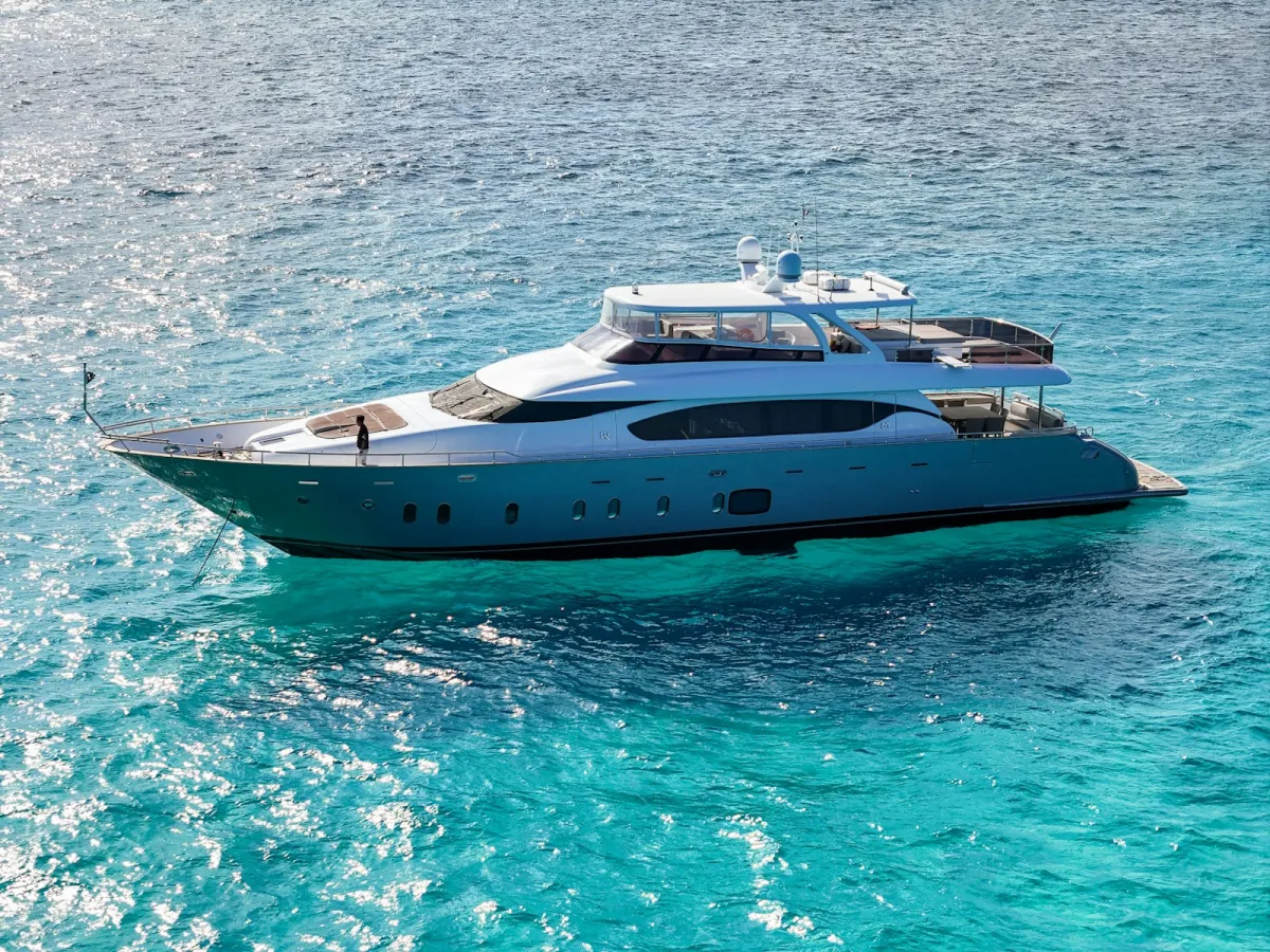Luxury motor yacht cruising on turquoise water