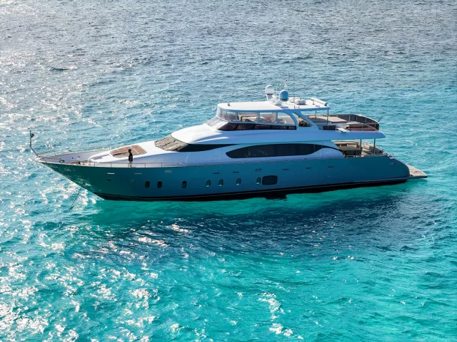 Luxury motor yacht cruising on turquoise water
