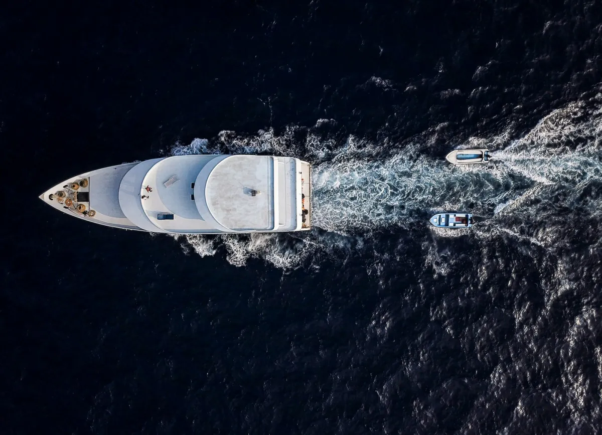 Aerial view of a white yacht cruising at sea