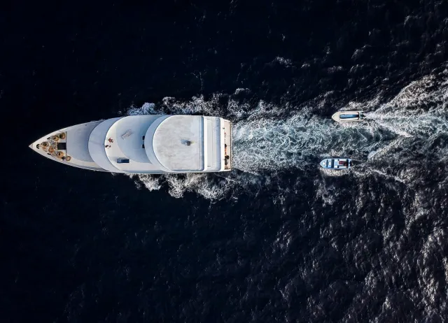 Aerial view of a white yacht cruising at sea
